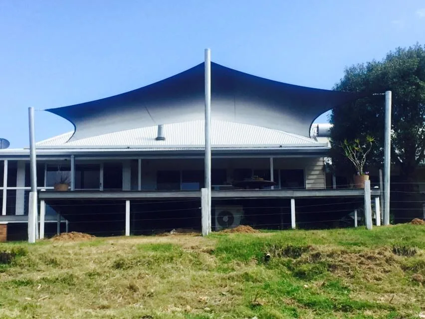 Black shade sail over a country home verandah