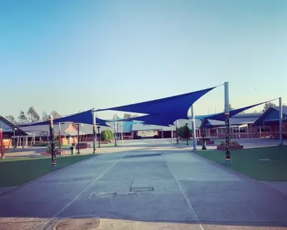 Blue shade sails over a school courtyard