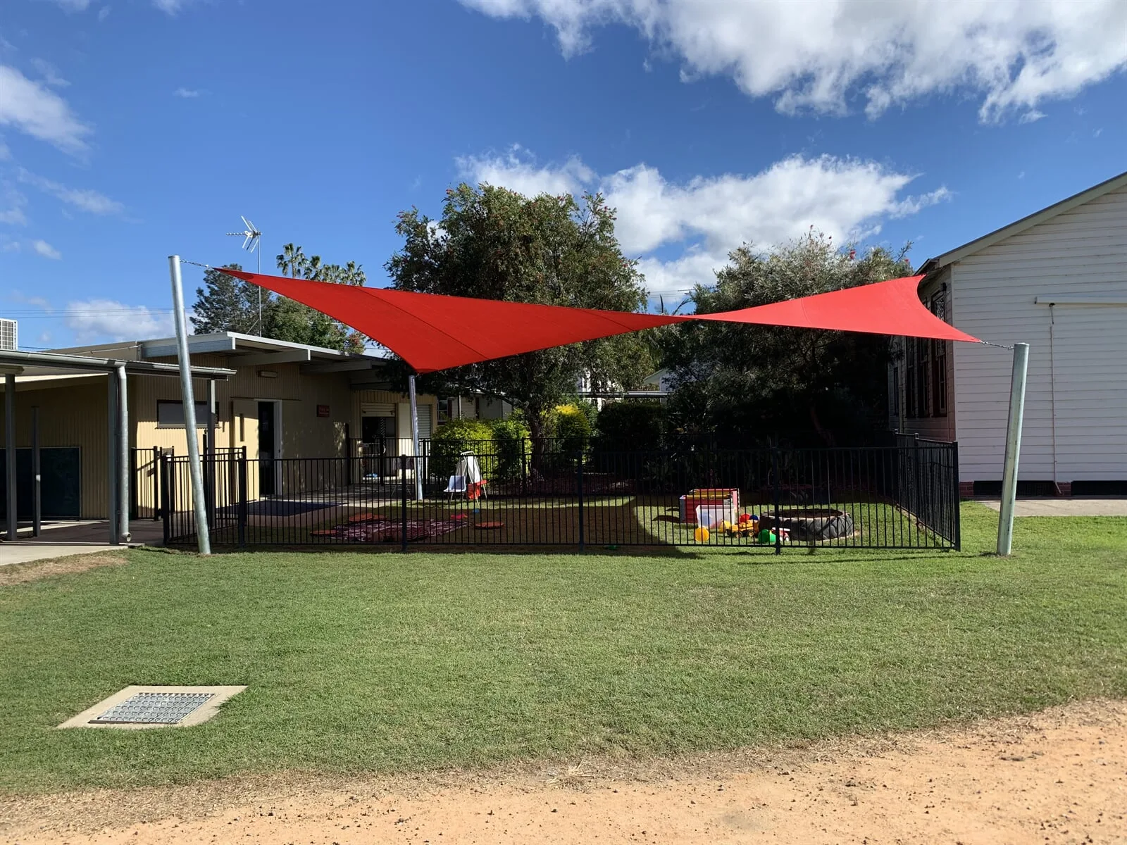 Charcoal shade sail on a rural property driveway