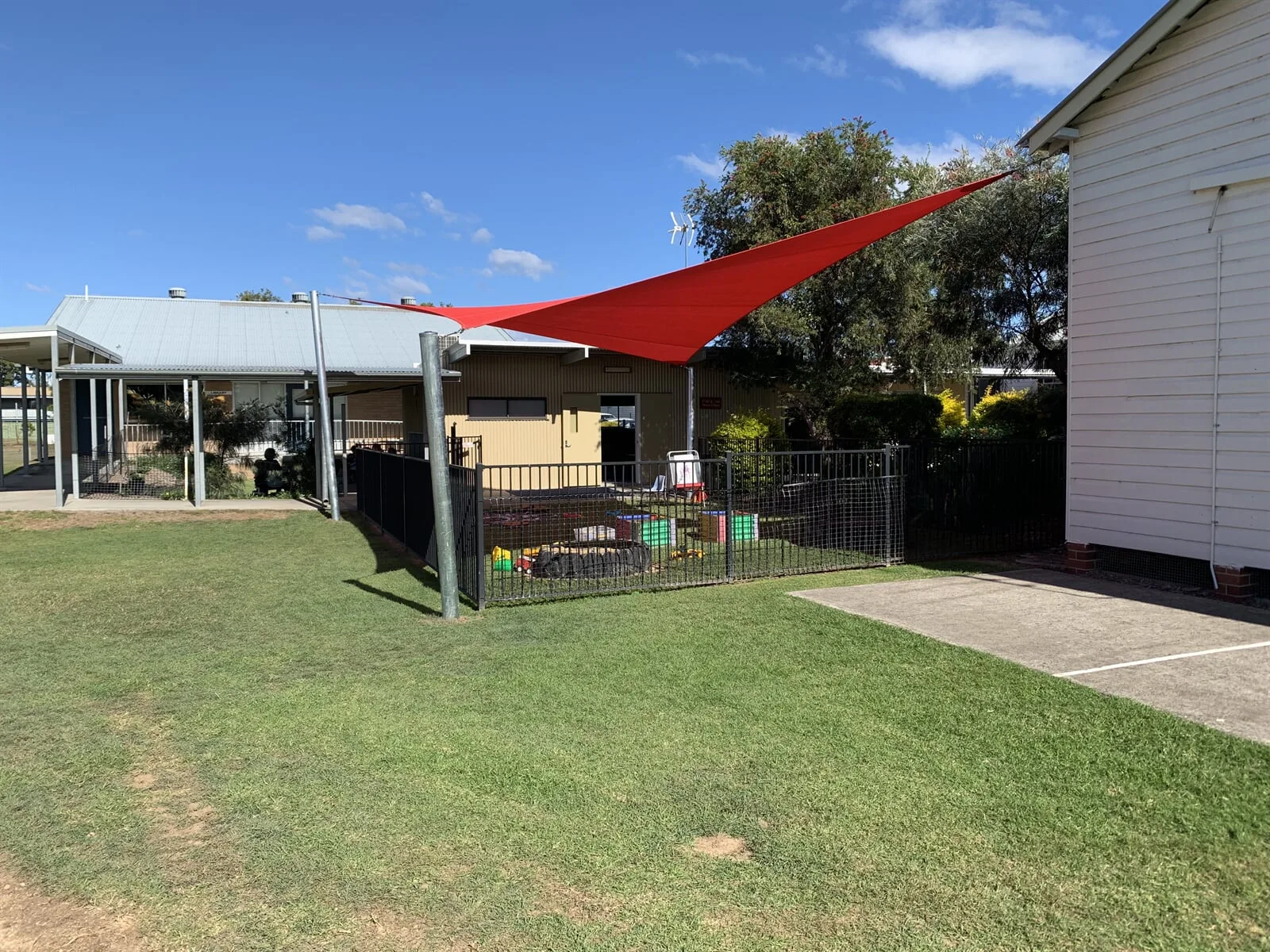 Charcoal shade sails over a modern tiled-roof home in Grafton