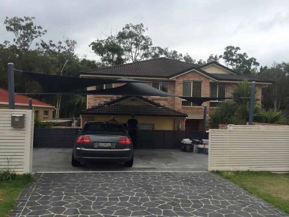 Grey shade sail over a modern hilltop home on the North Coast