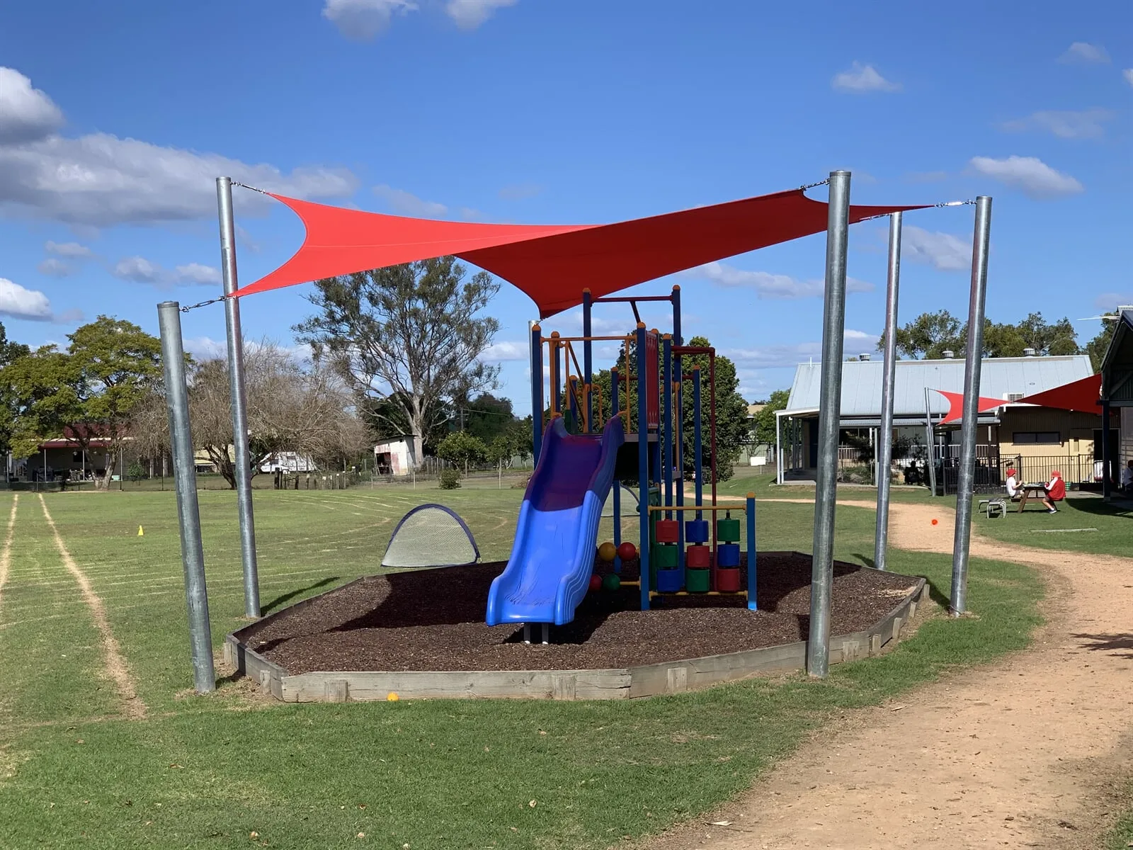 Red shade sails over a school playground slide