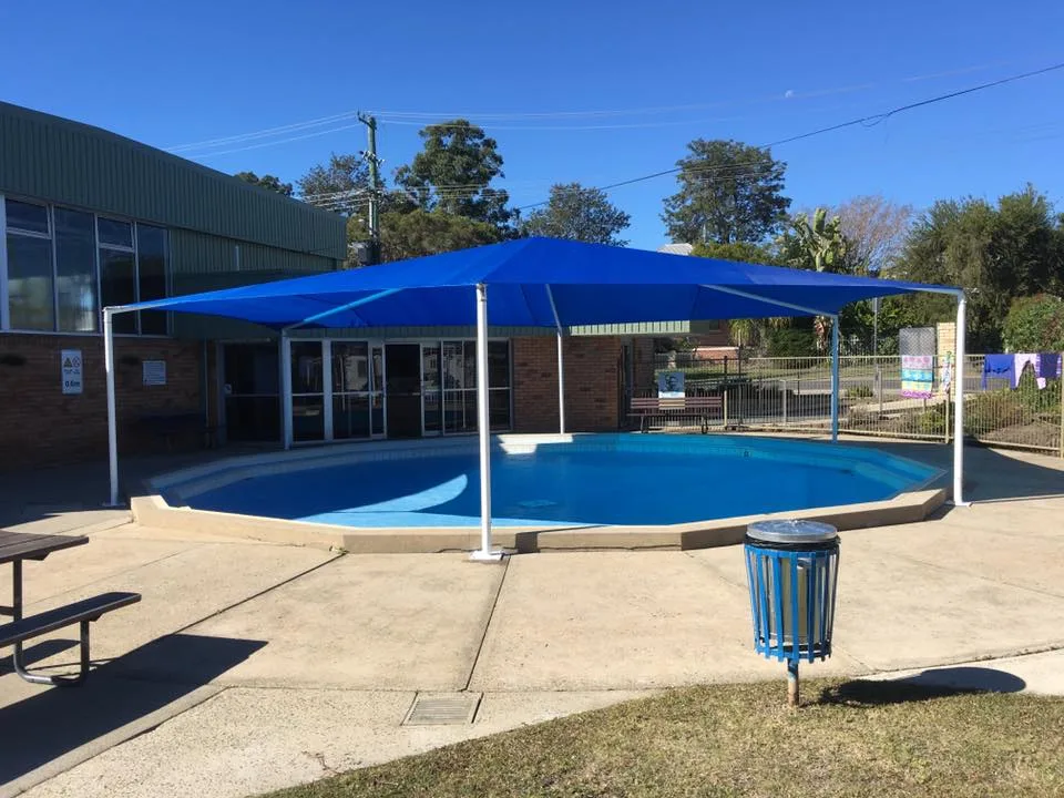 Red shade sail over a childcare playground