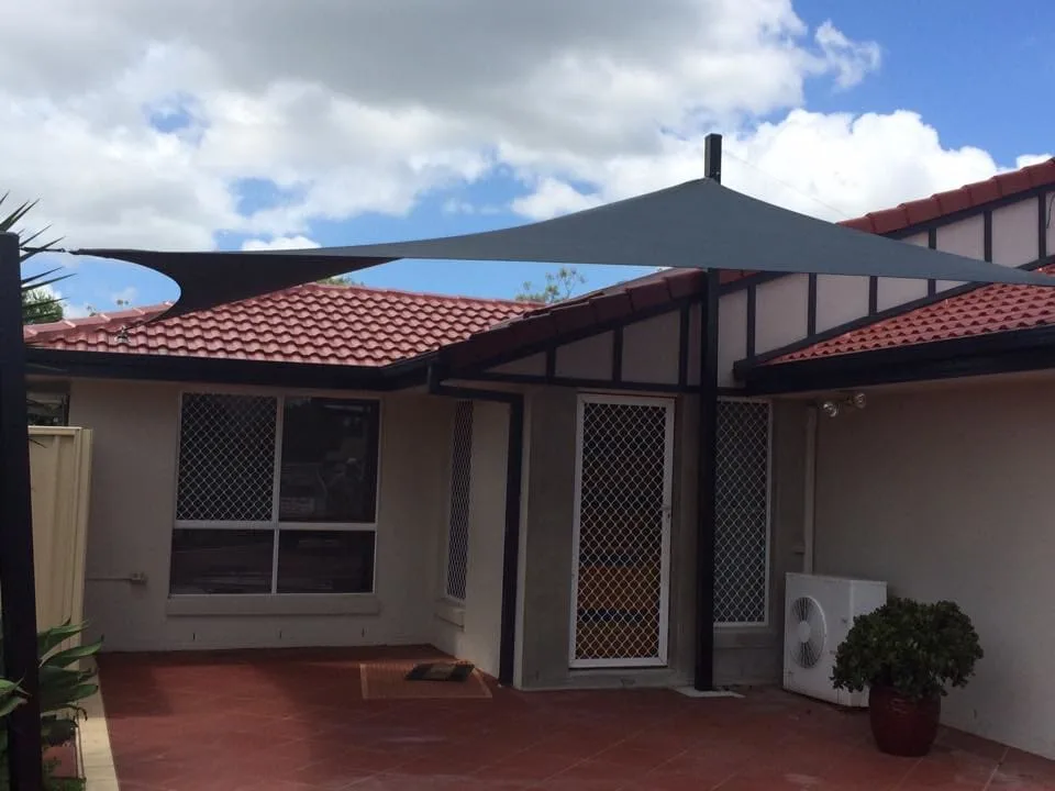 Red triangle shade sail at a residential property